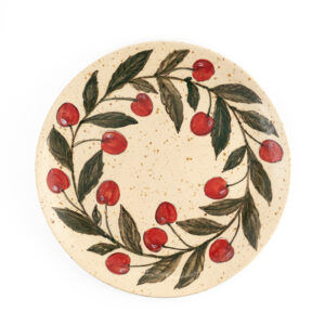 A large plate with berries by the ceramicist Helemall Maask